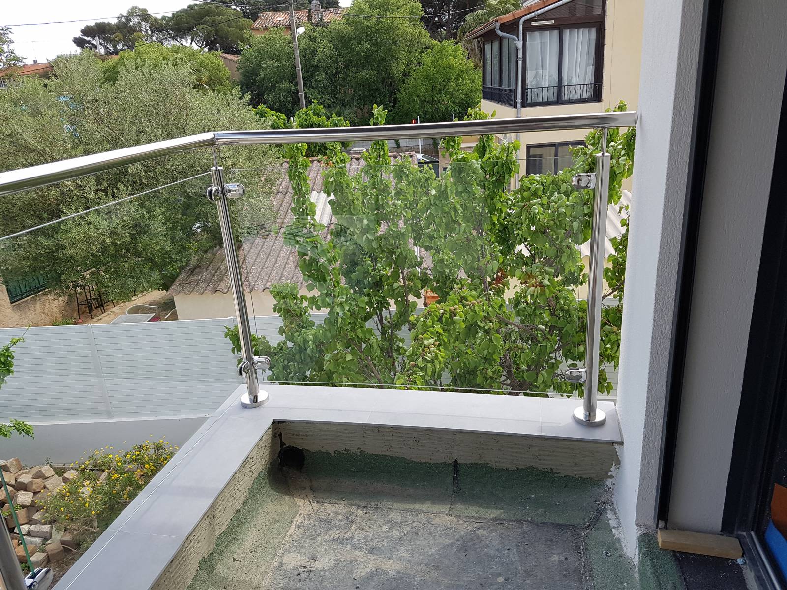 Détail de la façade de la maison avec rambarde en inox, offrant une touche d'élégance.