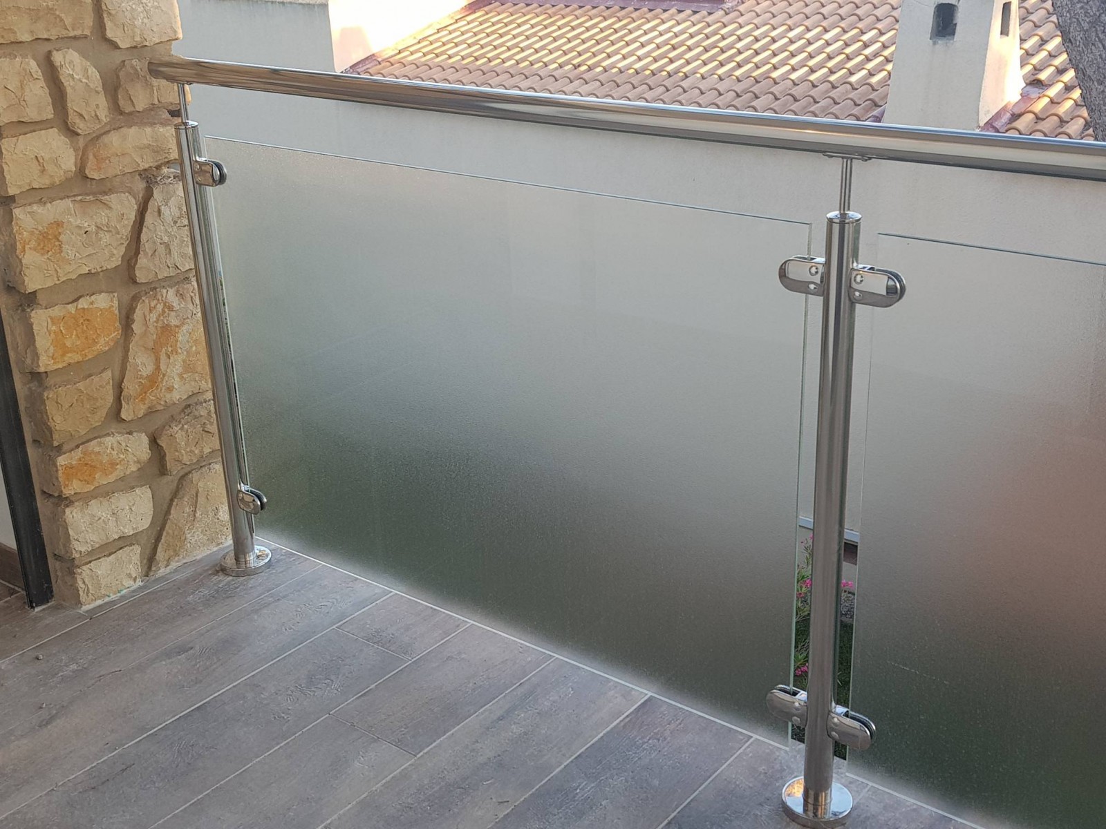 Détail du verre imprimé utilisé pour le garde-corps, laissant passer la lumière tout en agissant comme un brise-vue élégant.